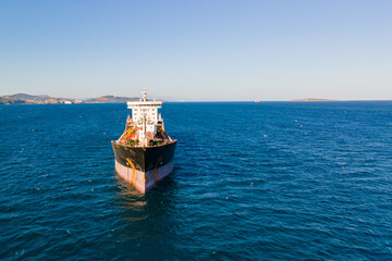 Front view on petrochemical oil product cargo ship carrier at anchorage in sea. Aerial view
