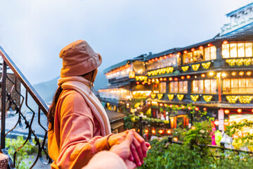 Young couple tourist traveling at Jiufen old street landmark and popular attractions in Taiwan - obrazy, fototapety, plakaty