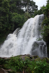 Beautiful Waterfall on the mountain and stream flowing on the rock of tropical rain forest in national park at Thailand