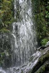 Fast waterfall on damp wall 