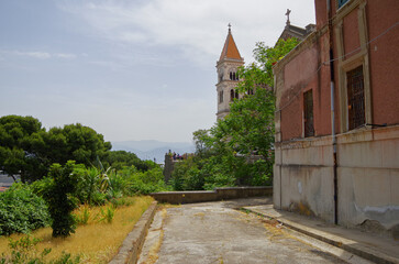 Fototapeta na wymiar Scenic panoramic view of historic old town downtown with historic building facades, parks, the church and cruise destination Messina, Italy close to Taormina on Sicily