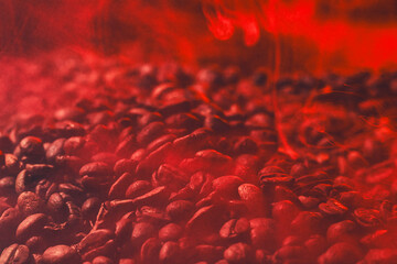 Roasted coffee beans with smoke and fire background. Close up,
