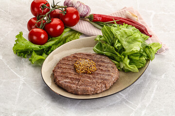 Frilled beef burger cutlet with iceberg