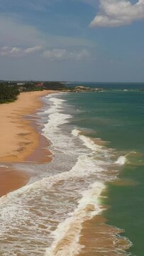 Top view of a beautiful sandy beach and ocean with waves. Lankavatara, Sri Lanka.