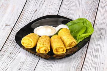 Stuffed pancakes with cream sauce