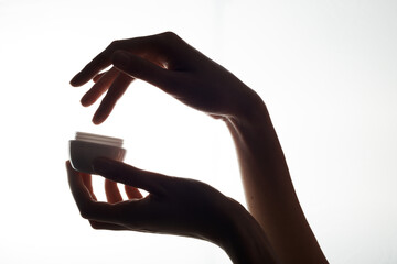 Close-up of a mockup of a white jar with moisturizer in a woman hand on a white background. A woman...