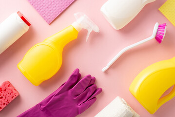 A neat pattern display of ordered housecleaning tools including gels, sprays, gloves, a dusting cloth, and sponge, all on a soft pink background with a clear area for text or labeling - obrazy, fototapety, plakaty