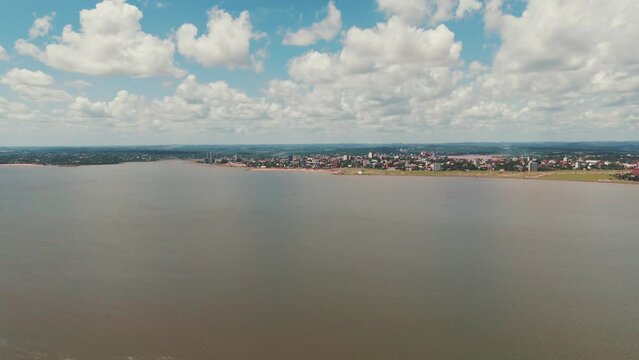 Long shot image of the coastal city Encarnación in Itapúa, Paraguay, highlighting the cityscape and its picturesque waterfront.