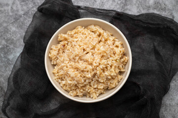 Whole grain brown rice cooked in small bowl