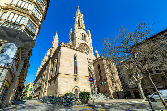 Catholic church under blue sky on the street of Palma, Spain.