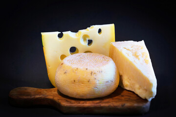 Cutting board with Emmental, Grana and Pecorino cheeses