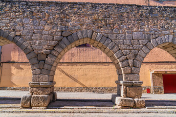 Street level low view of Segovia aquaeduct Spain historic Roman building