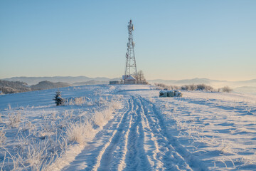 telecommunications tower in a winter mountainous setting