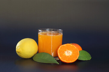 tangerine juice in a glass on dark background