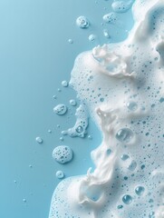 Spot of thick shampoo foam on a blue background. Top view. Studio photoshoot