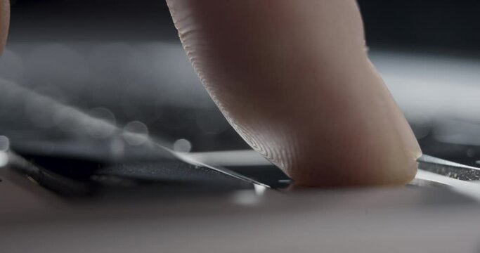 Close-up of Finger Pressing "Return" Key on Laptop Keyboard