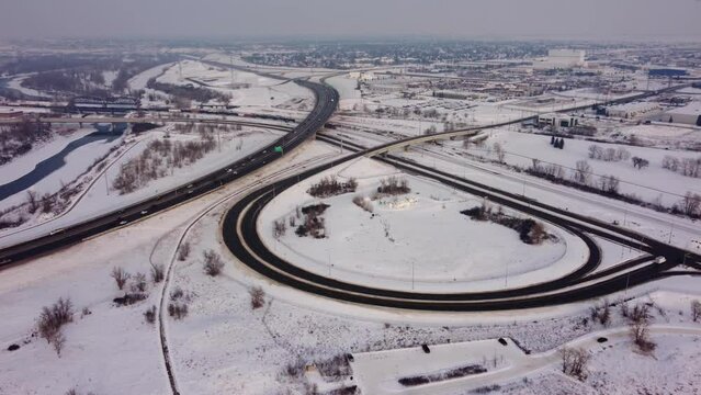 Aerial View of a Snow-Covered Highway and Exit Junction in Winter.