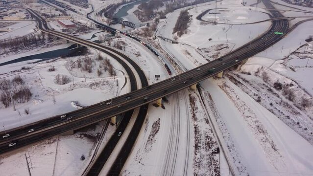 Heavy Highway Traffic and Canadian Pacific Train in Winter Time.