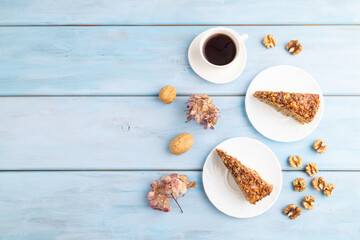 Walnut and hazelnut cake with caramel on blue wooden. top view, flat lay, copy space.