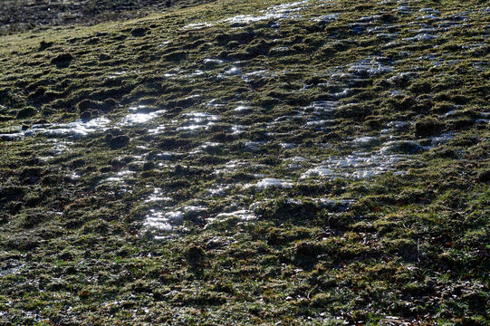 frozen water on the meadow like permafrost in winter