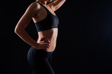 Fototapeta premium Happy fit woman over studio background. Smiling female fitness workout. Healthy lifestyle concept.