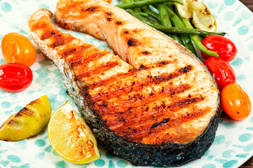 Grilled trout steak on a plate.