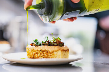 professional chef's hands cooking brioche with salmon mousse in restaurant kitchen
