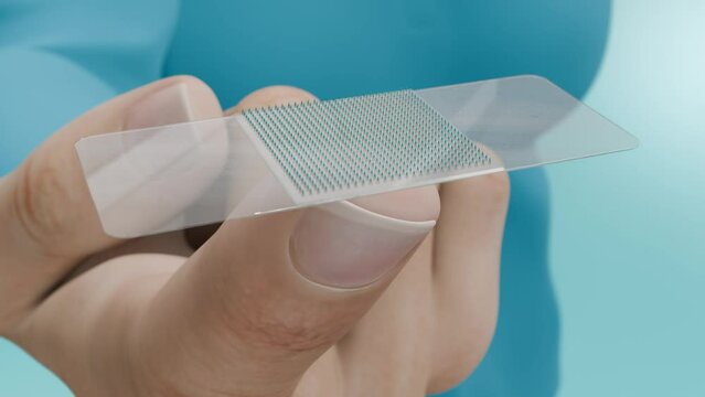 Close-Up of a Hand Holding a Skin Patch with Micro-Needles. Transdermal Vaccination: A Novel Method Using a Skin Patch with Micro-Needles. 3D animation.