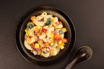 Macaroni Salad with Bell Pepper, Onion, Corn and Mayonnaise Dressing.