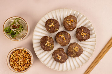 Tteokgalbi or Korean Grilled Short Rib Beef Patties, Top with Pine Nuts and  Served with Kimchi