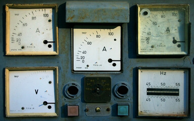 A wall adorned with a variety of gauges, displaying measurements such as temperature, pressure, humidity, speed, and voltage.