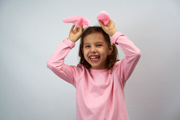 Funny happy child girl with Easter bunny ears