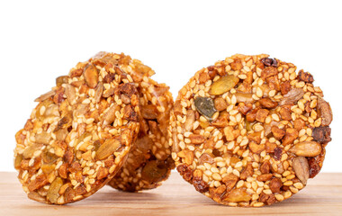 Several sweet thaler cookies on a wooden table, macro, isolated on white background.