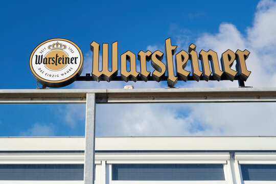Warsteiner premium beer sign logo and brand text on restaurant terrace railing. Warsteiner is a brewery in Warstein, Germany, in the Sauerland.