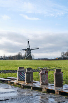 Old milk cans standing in a row. Carbide shooting is a tradition in the Netherlands and usually takes place on New Year's Eve. The goal is to make a loud bang after the carbide gas is ignited