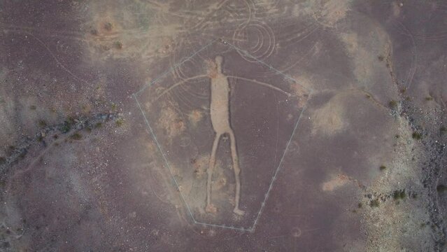 Slow Pull Up and Away from Blythe Intaglios in Arizona Desert, Ancient Geoglyph in Center of Frame Surrounded by Desert Terrain