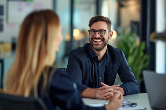 Happy businesswoman interviewing a well-prepared job candidate in a cozy office environment. The job interview process - from expectation to excitement, captured in high-definition