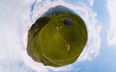 Aerial little planet view at the Koruldi lakes. Green hills, high mountain pastures. Summer day. in...