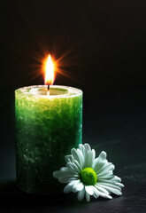 green candle with white flower on black background, funeral card concept.