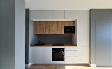 Installation built-in furniture and wiring kitchen. Upper cabinets in small kitchens are made to...