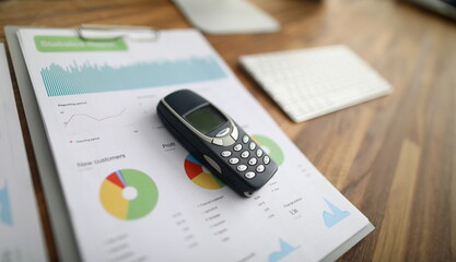 Phone is statistical report, profit from customers. Calling customers during self-isolation. Calculation profit and loss during quarantine. Workplace at home. Analysis for certain period