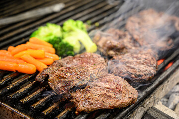 Barbeque grill steak and vegetables (broccoli and carrots)