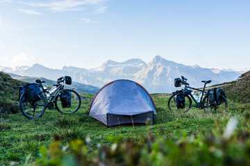 Camp on a bike travel with two loaded bikes with panniers and a tent in between on a mountain pass...