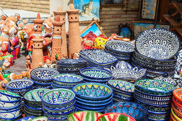 Ornamented ceramic bowls and models of Islam-Khodja (Islomxo'ja) minaret. Typical handmade Khiva's...