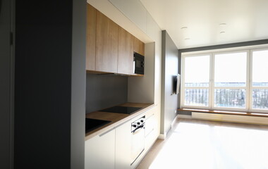 Interior kitchen after repair electrical networks. Wiring in apartment. Backup power source. Sockets and switches in kitchen. Built-in furniture in modern apartment