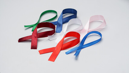 Colorful ribbons on white background, World Cancer Day