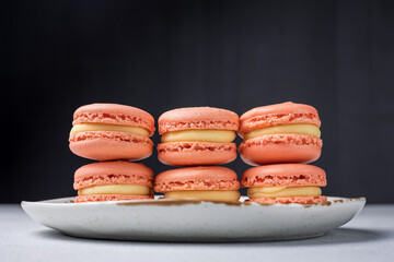 Orange macaroons with yellow filling. Close up