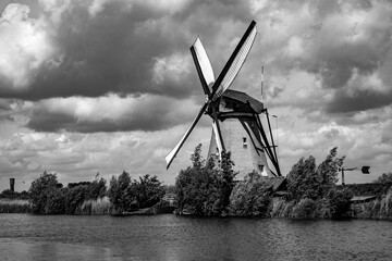 Vintage panorama with windmill in “Kinderdijk“, popular dutch tourist attraction and world...