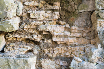 Fragment of a dilapidated medieval stone wall.