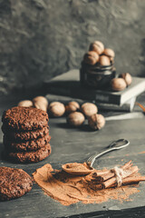 Spiced cookies and cinnamon on wooden background.